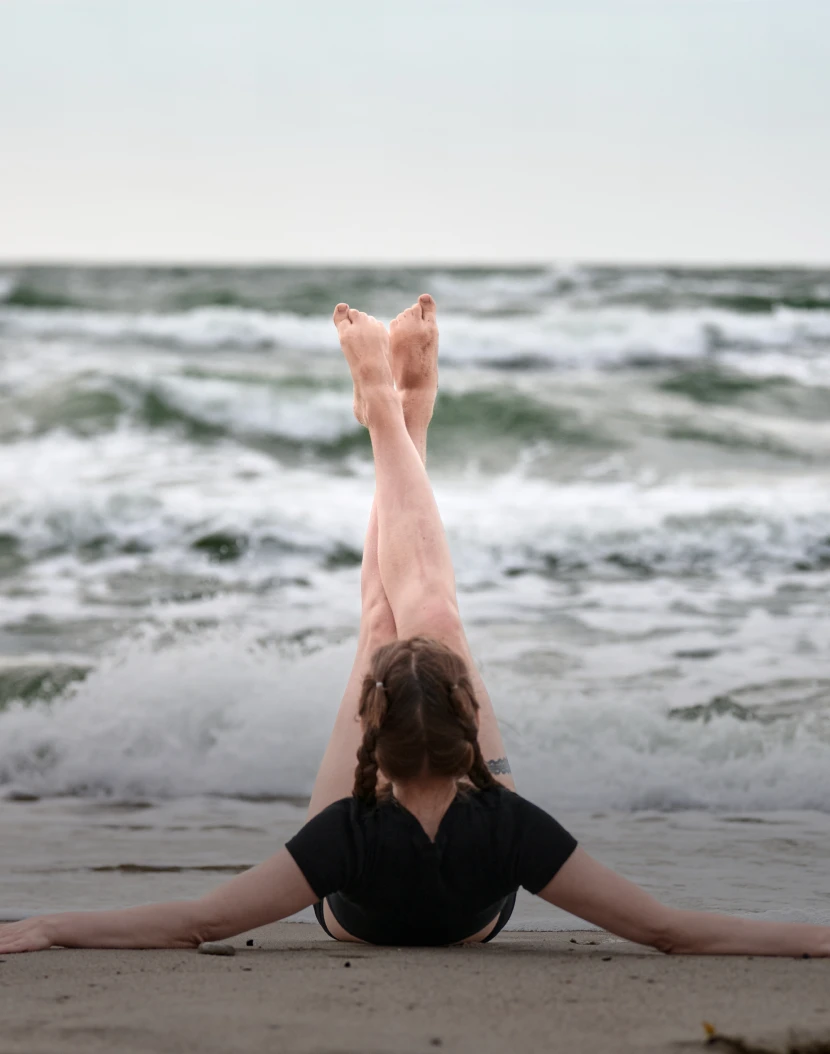 Beach yoga pose near water